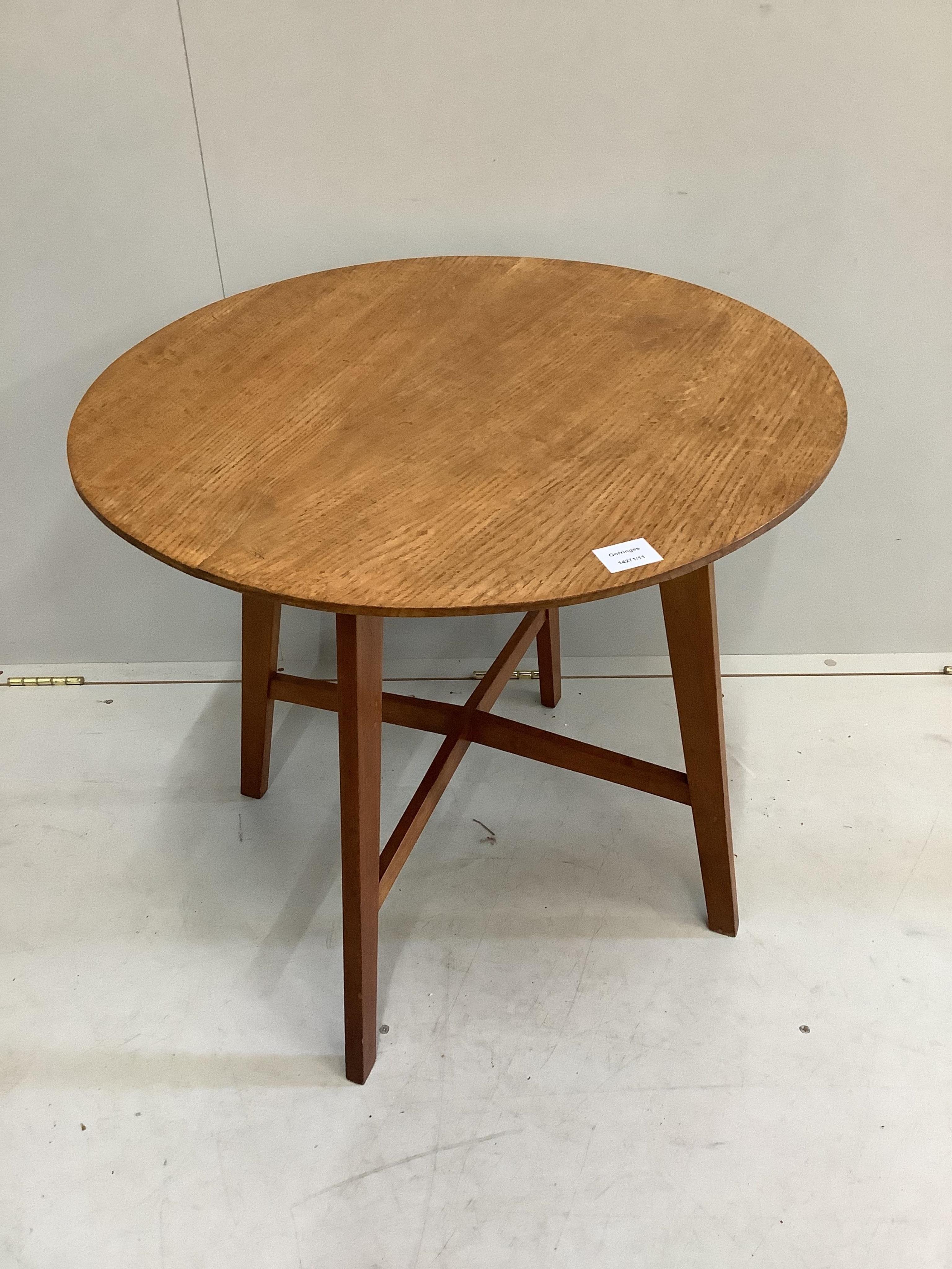 A mid century circular oak coffee table, diameter 67cm, height 61cm